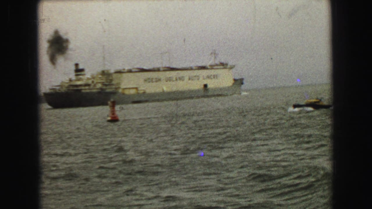 Ocean liner with funnel smoke, red buoy, and small speedboat on the right.
