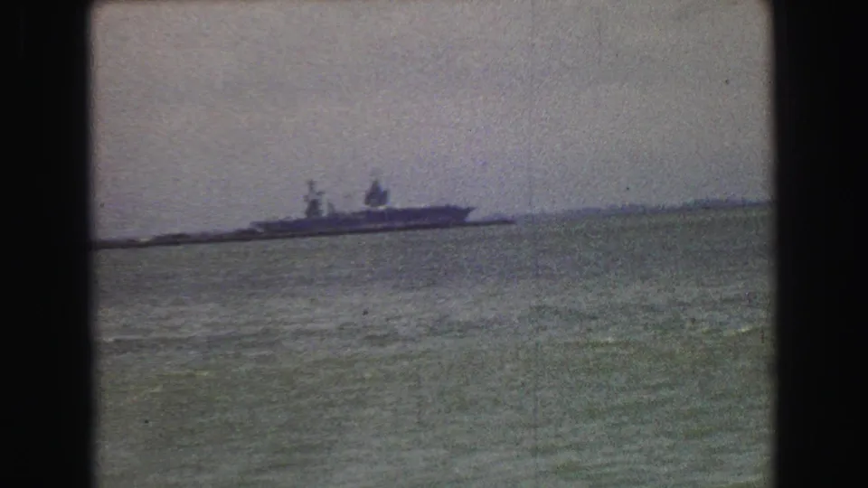 1968 Vancouver-area home-movie frame showing a distant ship on water with a low horizon and heavy 8mm grain.