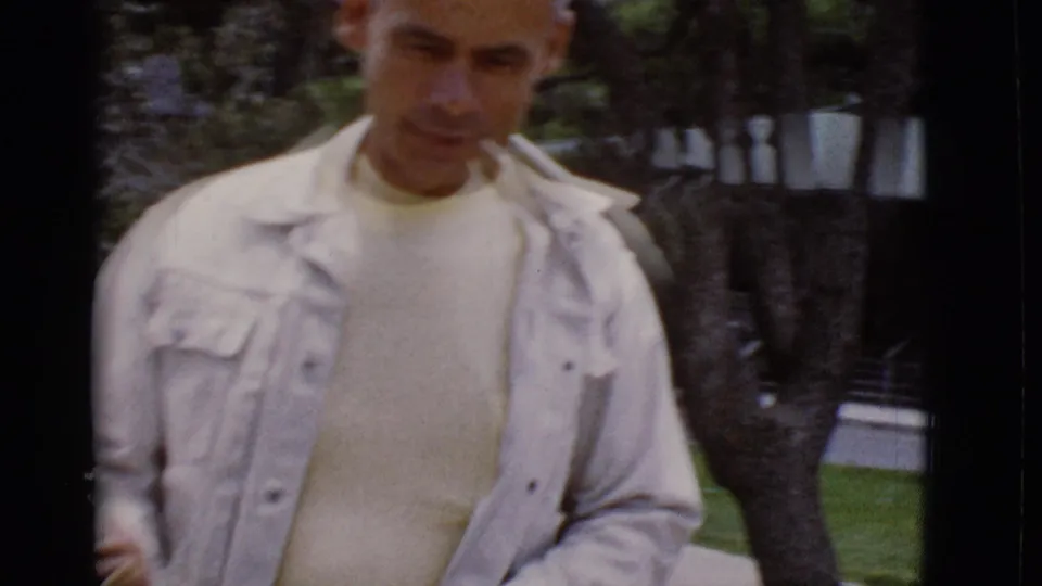 Adult man in a pale jacket appears close to the handheld 8mm camera in an outdoor Arizona setting from the supplied 1968 metadata.