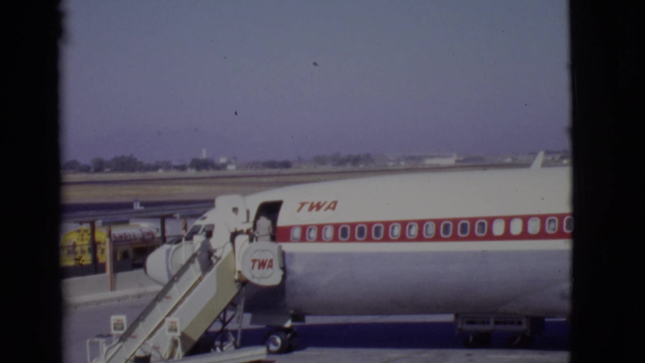 TWA aircraft side with boarding stairs positioned at the front door.