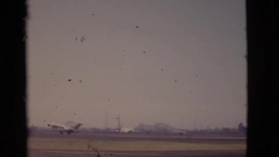 At the end of the clip, the distant jet appears to lift or accelerate along the Arizona runway against a hazy airport horizon.