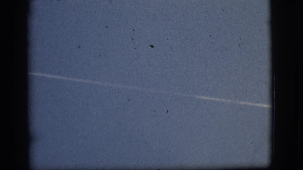 Pale blue sky with a faint white horizontal streak and dark 8mm frame borders.