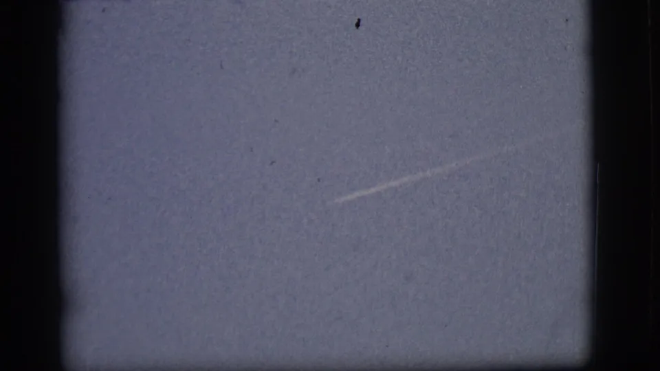 A faint jet contrail appears across the pale Flagstaff sky in this 1968 8mm home-movie frame.
