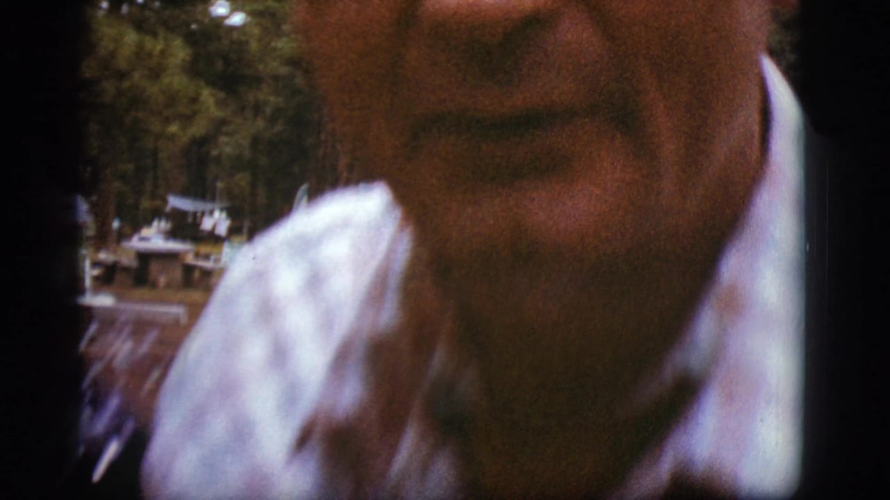 Close, soft-focus view of a man in a plaid shirt and tie.