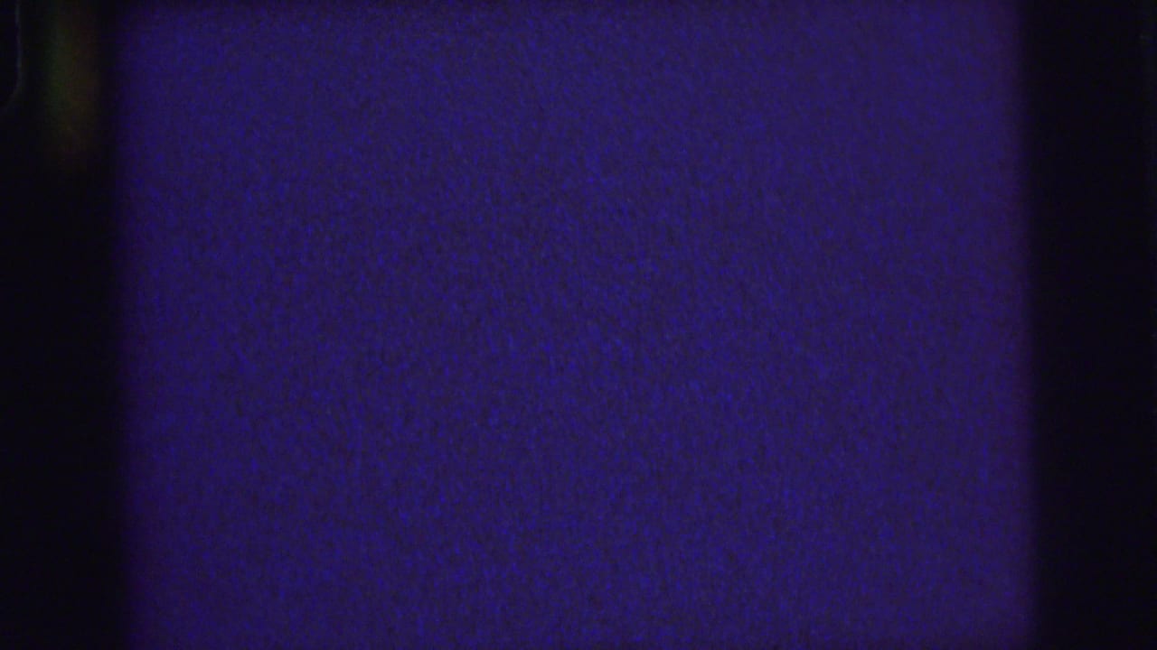 Deep blue and purple film frame with dark gate edges and visible grain.