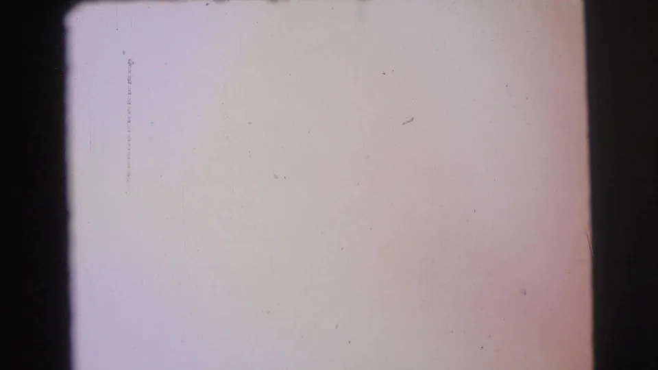 Overexposed 1971 8mm frame from the Yellowstone-area clip, showing pale film surface, dust, scratches, and dark border.