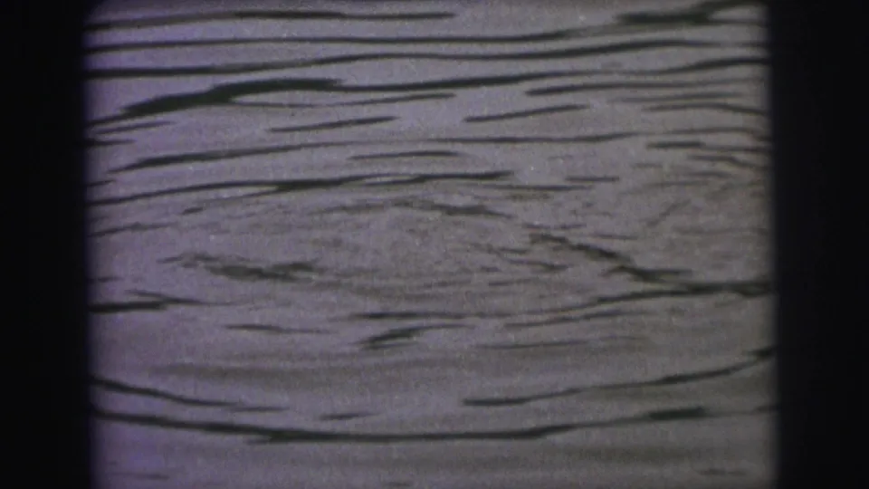 Rippling lake water in a purple-blue 8mm frame from the Superior, Wisconsin home-movie clip.