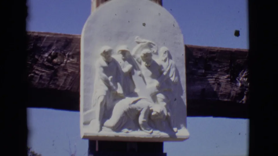 1965 San Luis, Colorado 8mm frame focusing on the relief sculpture for the seventh Station of the Cross.