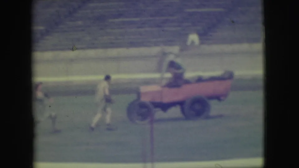 The final 1949 Denver frame shows the red cart on the grass with one person aboard while other figures move across the ballfield.