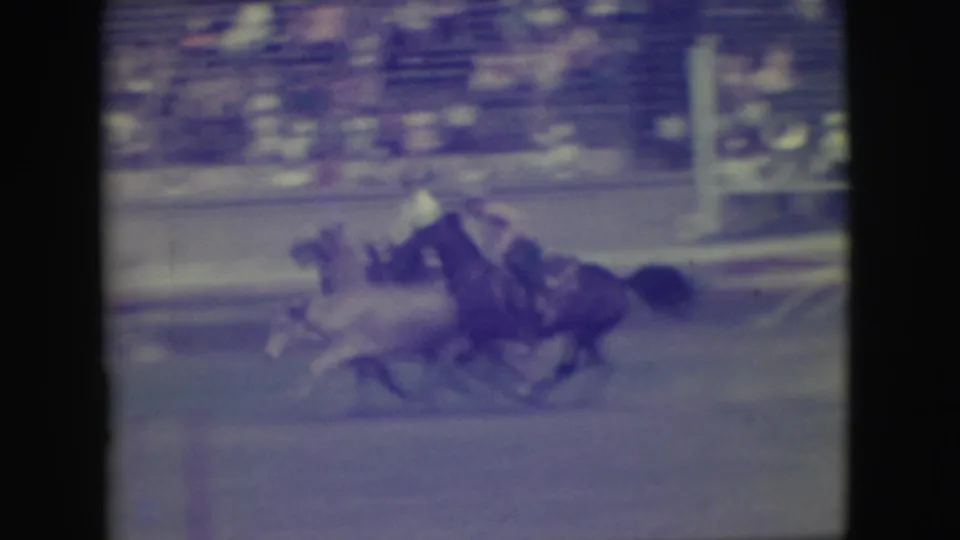 The 1949 Denver race footage shows horses and riders bunched together in a chaotic fall or near-fall on the racetrack.