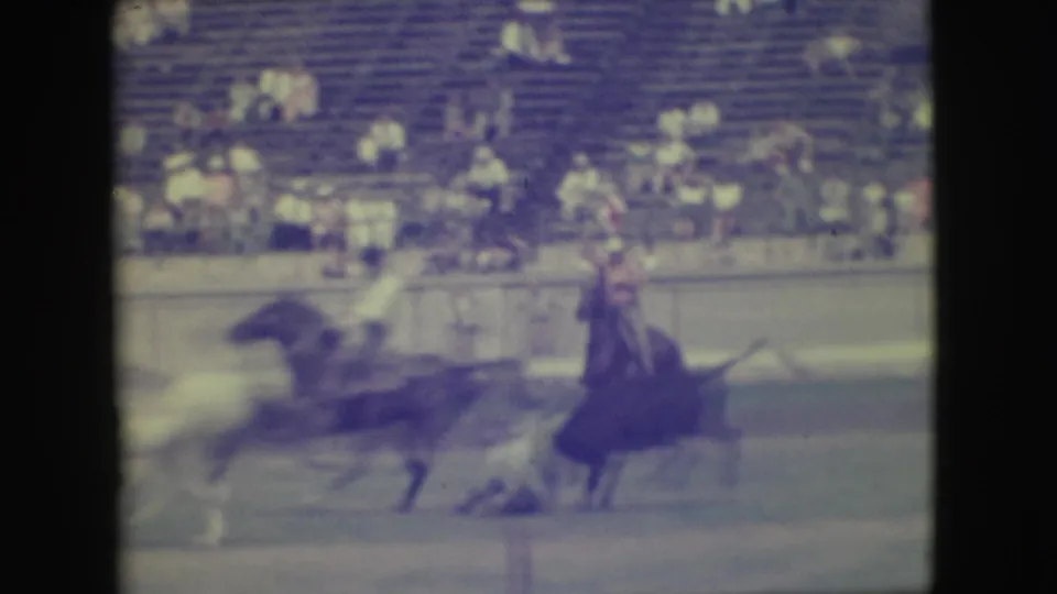 In the 1949 Denver rodeo scene, a dark bull runs through the arena while a mounted cowboy follows near the rail.