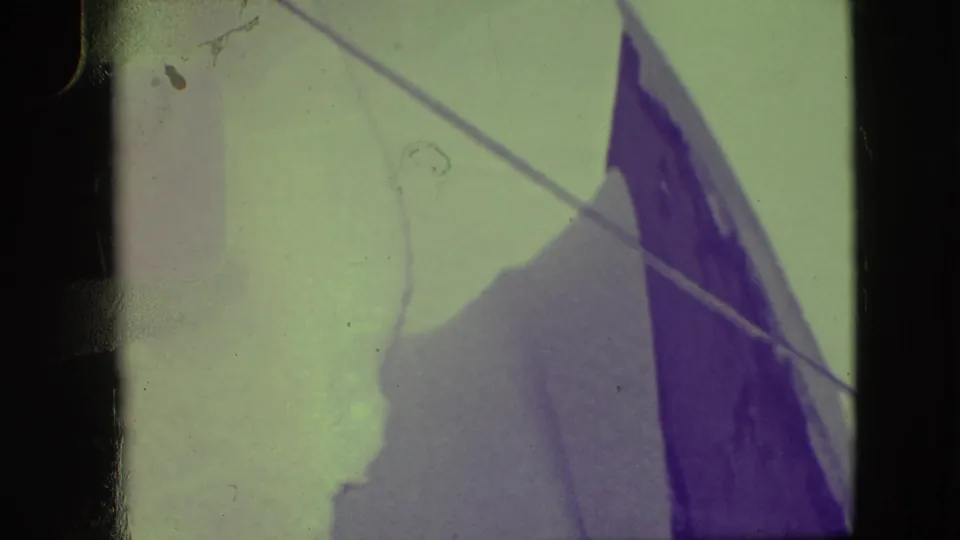 Color-shifted 8mm frame showing sail panels and rigging lines, with dark frame edges and visible surface wear.