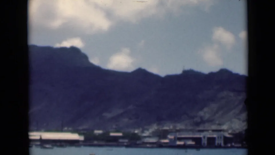 Final frame of the metadata-identified Aden coastal view, with buildings along the waterline and mountains filling the background.