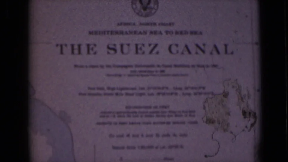 Printed Suez Canal title-card page with large heading, smaller route text, and map detail, framed by dark 8mm edges.
