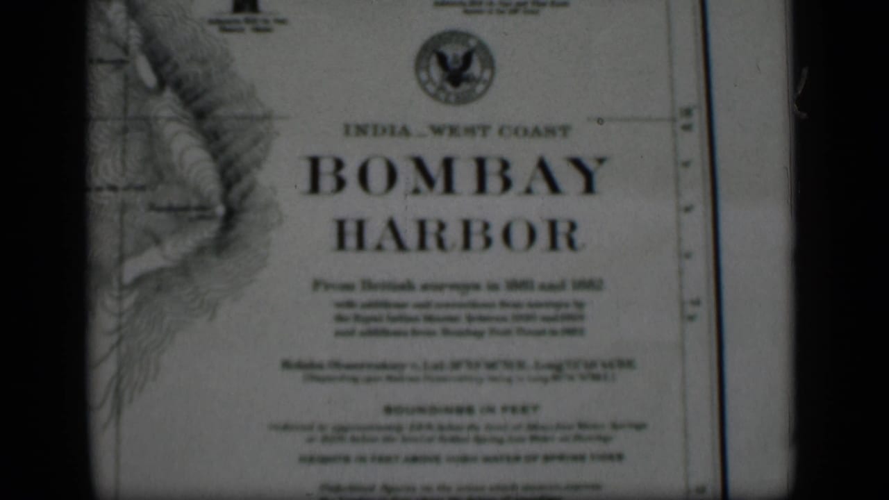 Close 8mm view of the Bombay Harbor chart, with the title, printed survey notes, and dark frame edge visible.