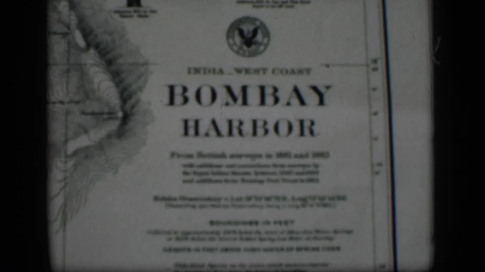 Close 8mm view of the Bombay Harbor chart, with the title, printed survey notes, and dark frame edge visible.