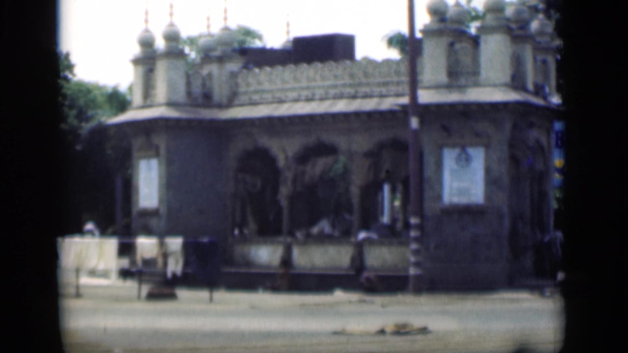 Similar view of an ornate building framed by dark film edges.
