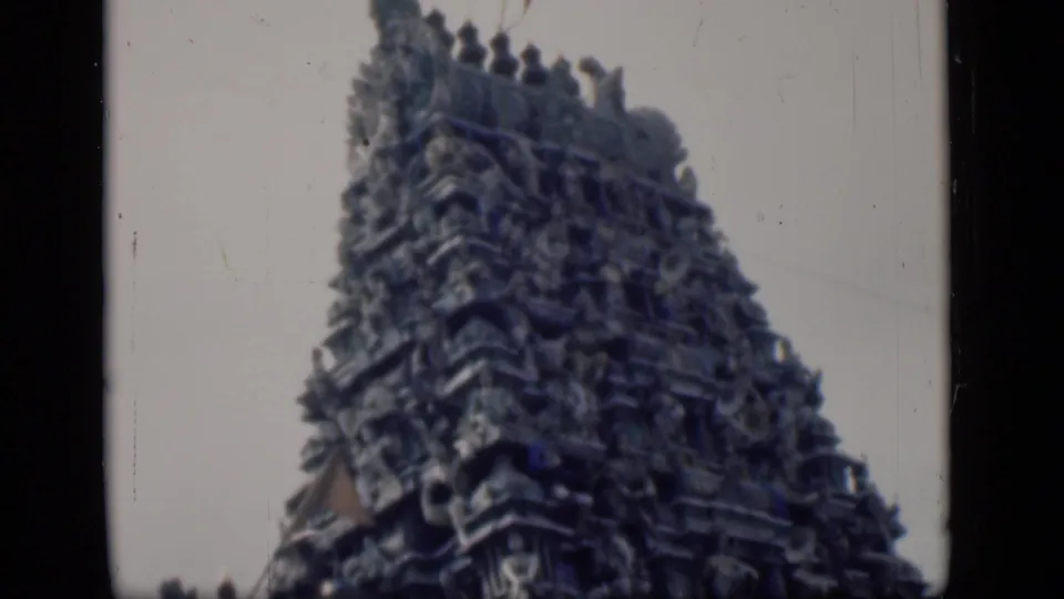 1946 Bombay frame of a tall carved gopuram, with sculptural detail visible through grain and faded color.