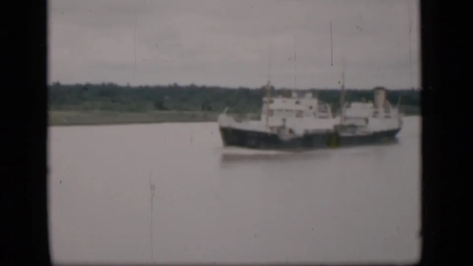The 1946 Bombay harbor view holds on the cargo ship as it sits farther right in frame, with grain and light film marks visible.