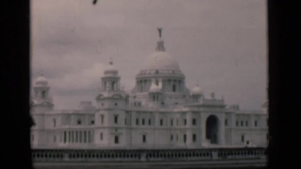 Soft 8mm view of the supplied Victoria Memorial Hall identification, with domes, columns, and a foreground balustrade.