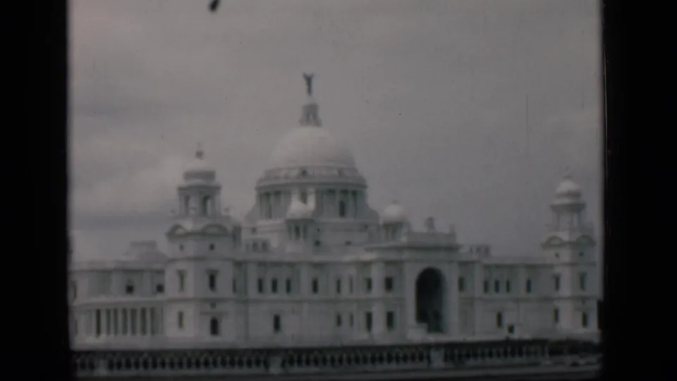 1946 8mm view identified as Bombay, India, showing a white domed landmark with side turrets and an arched entrance.
