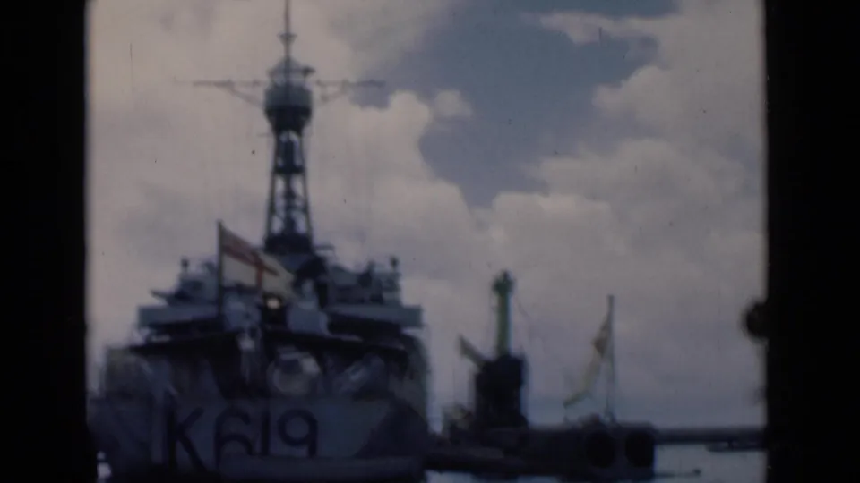 The vessel marked K619 sits partly left of frame in Colombo harbor, with a marker, flags, rigging, and open water under clouds.