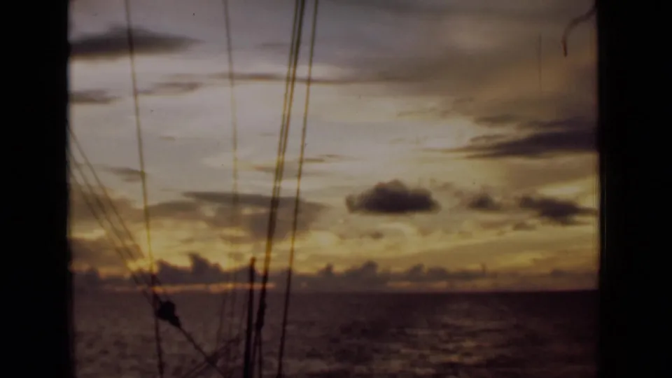 Final 1946 shipboard sunset frame near Colombo, with soft 8mm color and rigging over the sea.