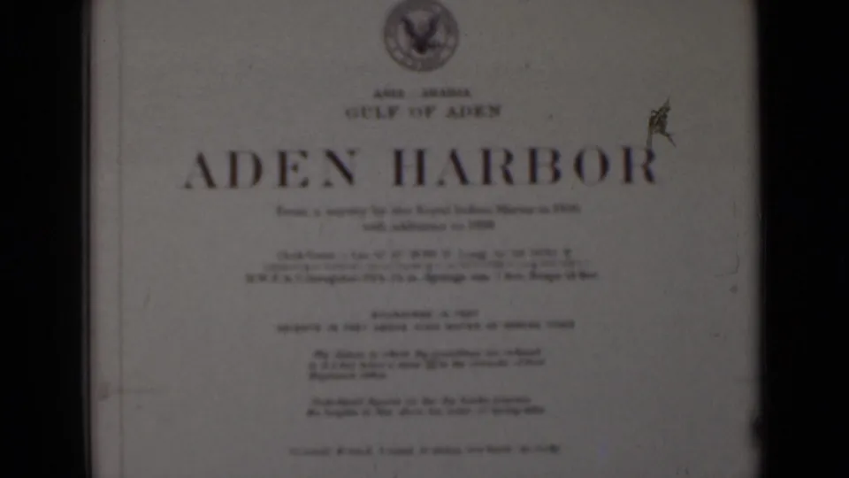 Repeated 8mm view of the Aden Harbor title card, with a visible emblem and film wear near the right side.