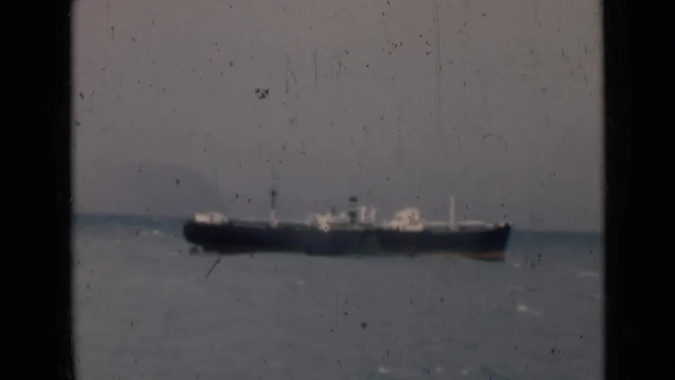 1946 India 8mm frame showing the ship lower in the view, with sea surface, horizon, and aged film texture.