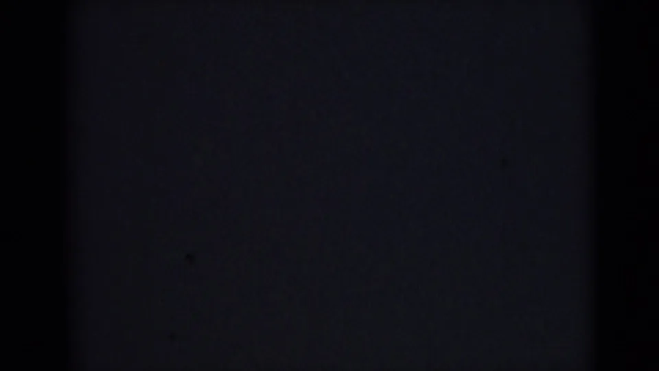 Very dark final frame from the 1946 India 8mm clip, showing mottled grain, low exposure, and soft edge shading.