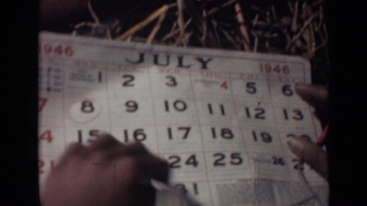 Hands point at a July 1946 calendar page with a circled date.