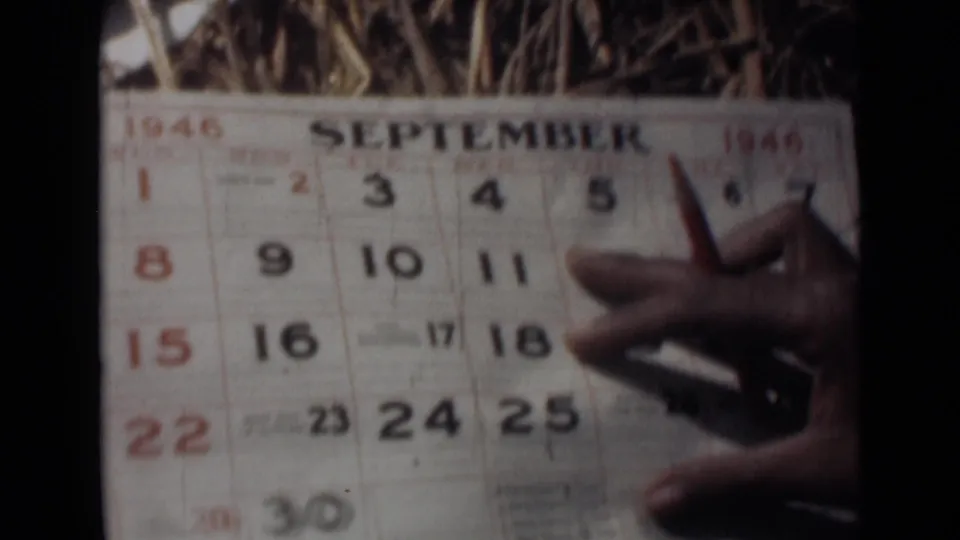 September 1946 calendar page appears with a hand and pointed object near the printed date grid in grainy 8mm footage.