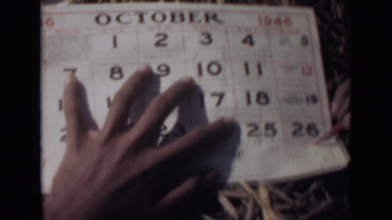 Hand spread across an October 1946 calendar page.