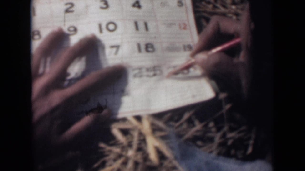 A red pencil marks the lower portion of the October 1946 calendar while another hand holds the paper steady on straw.