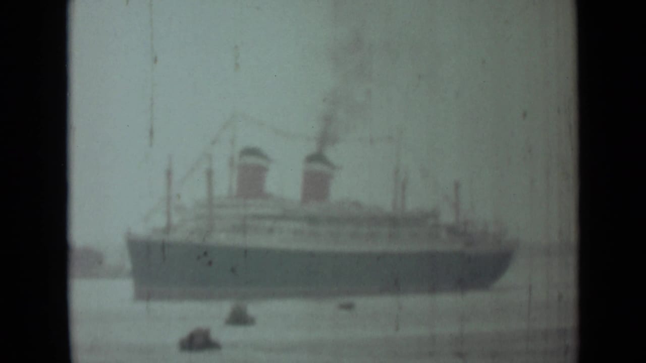 1946 India 8mm view of a large twin-funnel steamship on open water with smoke rising above it.