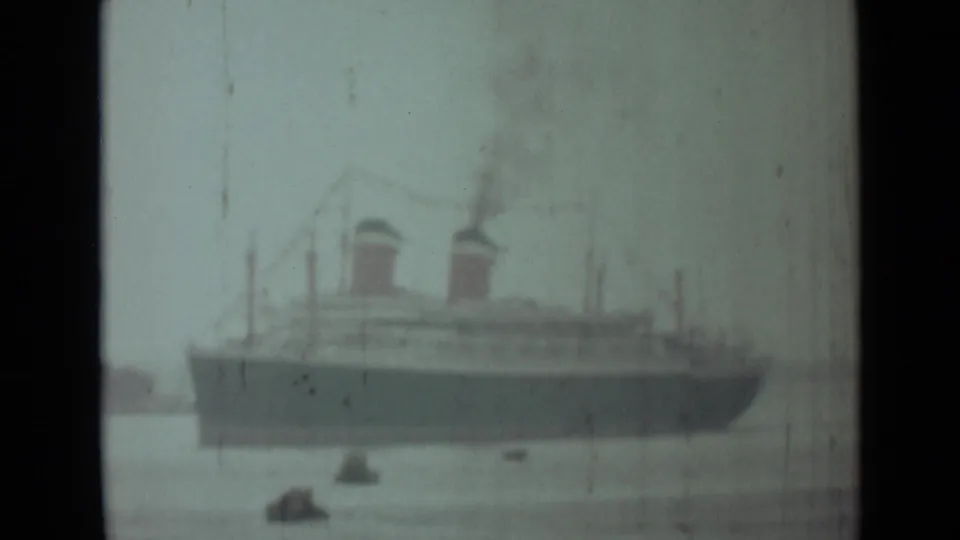 1946 India 8mm view of a large twin-funnel steamship on open water with smoke rising above it.