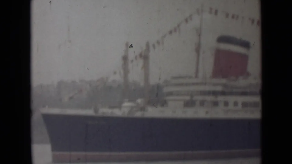 1946 India 8mm frame showing a closer section of the liner with signal flags strung above the decks and a red funnel.