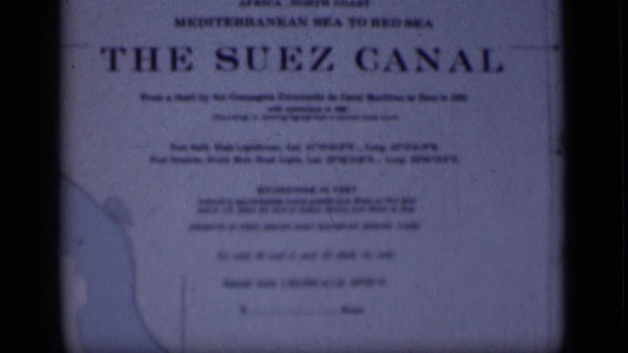 1946 Egypt 8mm frame of The Suez Canal sign, showing soft typography, a left-side map outline and blue-toned film texture.