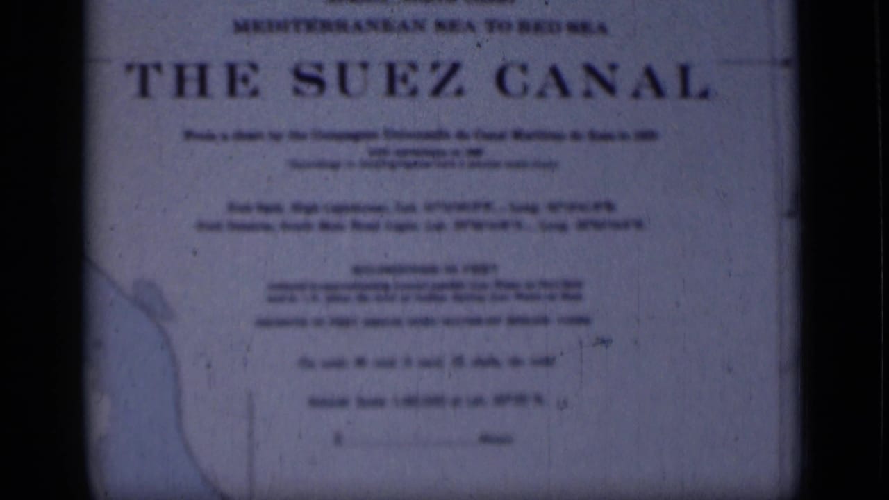 Final 1946 8mm frame showing the Suez Canal sign in Egypt, with route wording, pale map detail and aged blue film texture.