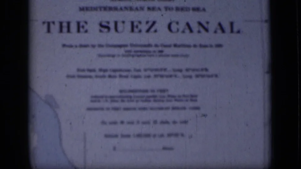 Final 1946 8mm frame showing the Suez Canal sign in Egypt, with route wording, pale map detail and aged blue film texture.