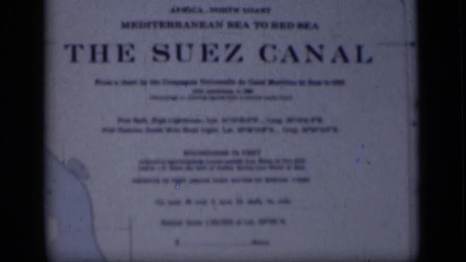 1946 home-movie title card for The Suez Canal, softly focused and framed by dark 8mm film edges.