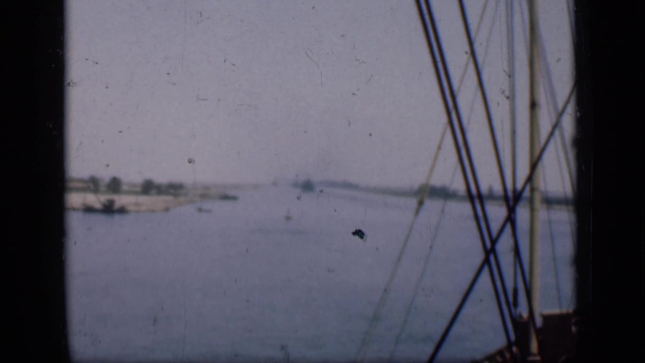 Canal water seen from a vessel with rigging along the right edge.