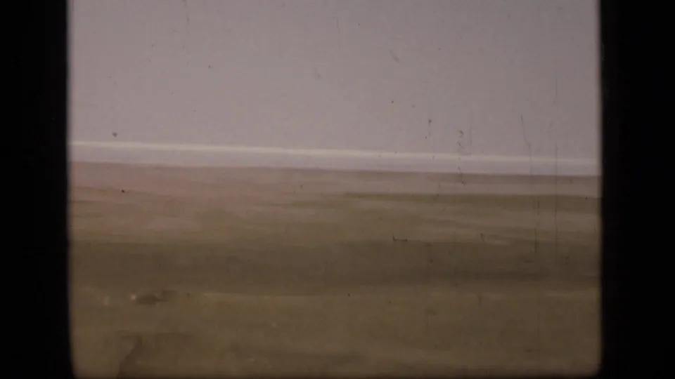 1946 home-movie frame showing a sparse desert view near the Suez Canal region, with soft focus and visible physical-film marks.