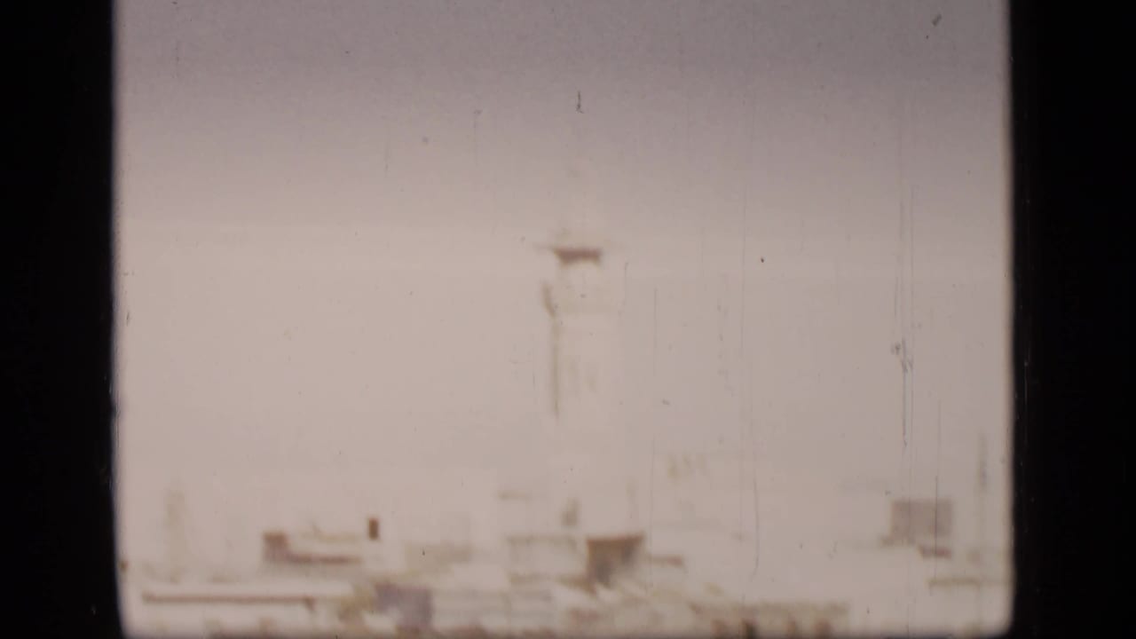Hazy pale shoreline or city edge with dark 8mm frame borders.