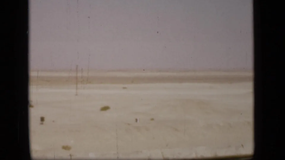 1946 Suez Canal area footage showing a flat sandy desert horizon with small scrub and visible 8mm film borders.