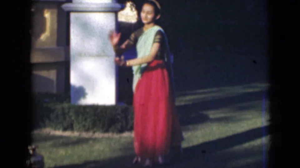 The final frame shows the costumed young woman smiling and gesturing in the 1947 India outdoor home-movie performance.