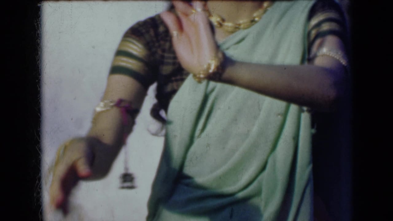 In the final frame, one adorned hand rises and the other lowers beside the woman’s green sari.