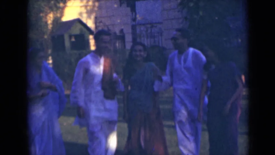 Near the end of the clip, adults in traditional attire are close to the camera, with soft focus and strong color shift.