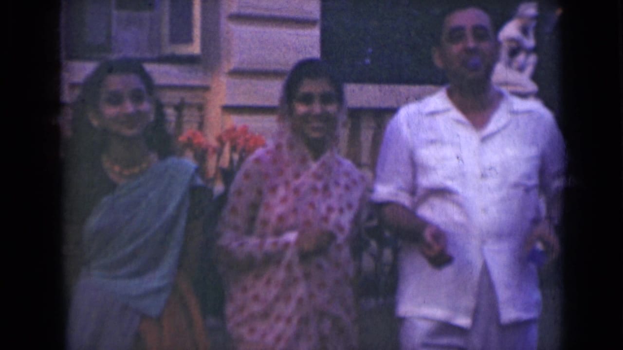 At the end of the 1947 India clip, two women and a man face the camera in a relaxed outdoor group pose.