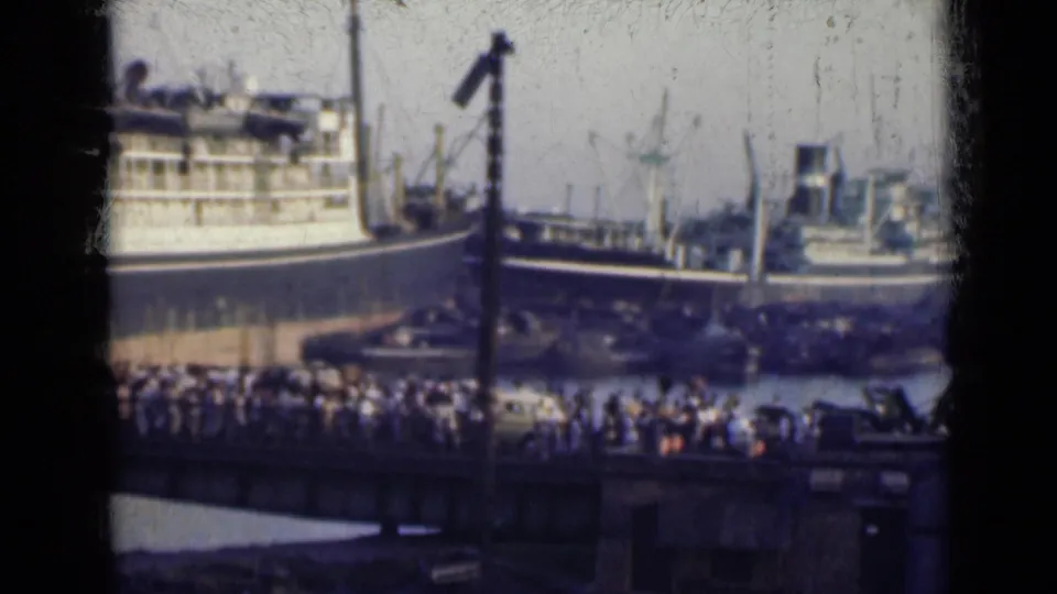 A second 1947 India harbor view shows passengers or onlookers along the waterfront with ships and cranes behind them.
